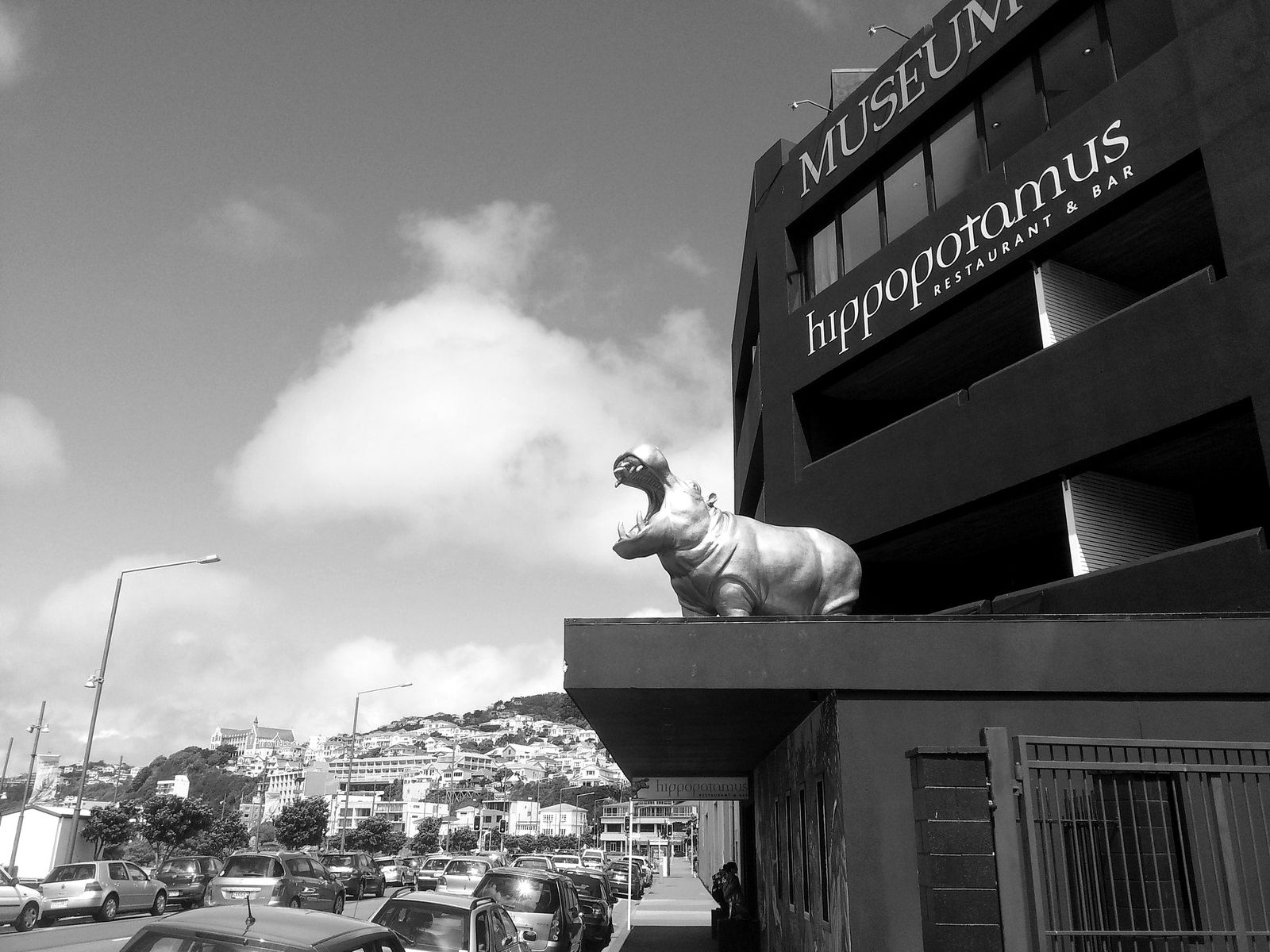 The gold hippopotamus sculpture on the ledge of the Museum Art Hotel in Wellington, New Zealand, above the Hippopotamus Restaurant and Bar
