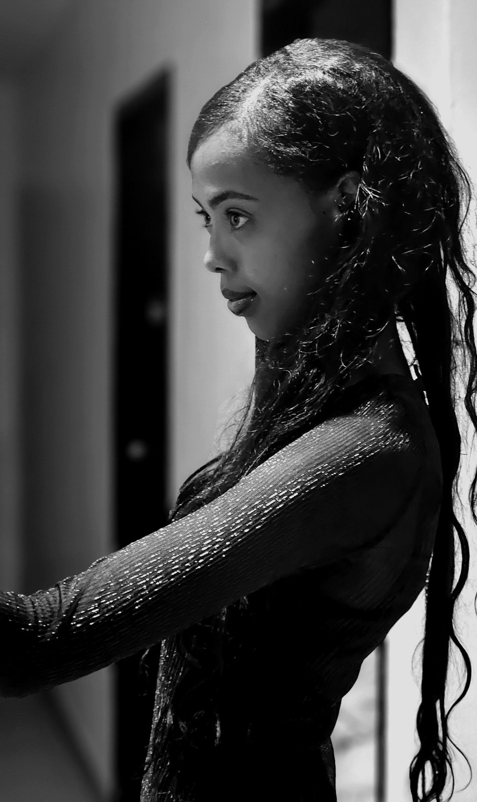 Amen, lead creator and face of Afrofeast, photographed in profile in black and white under natural window light